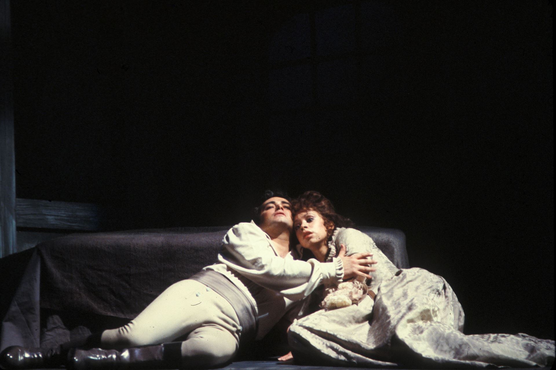 A man and a woman alying on the floor holding each other