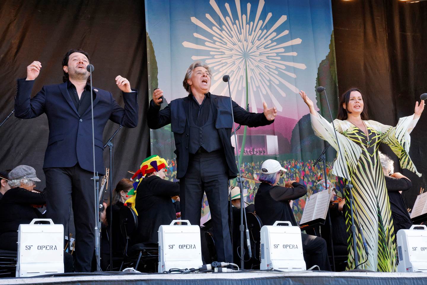 Three performers on stage at Opera in the Park 2023