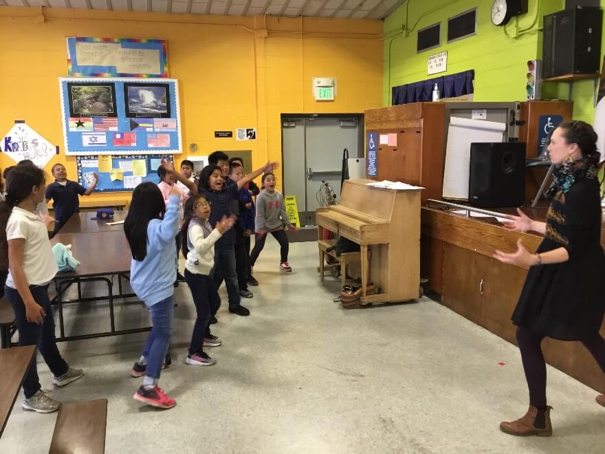 SFO teaching artist Katie Issel Pitre working with Mr. Won&rsquo;s 4th grade class, helping them express emotion through physicality.