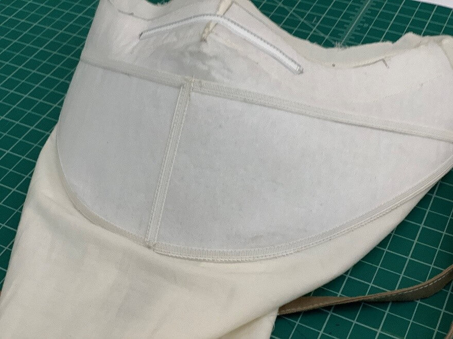The internal structure of the mask showing the pellon fabric, the rigilene boning, and the nosewire.