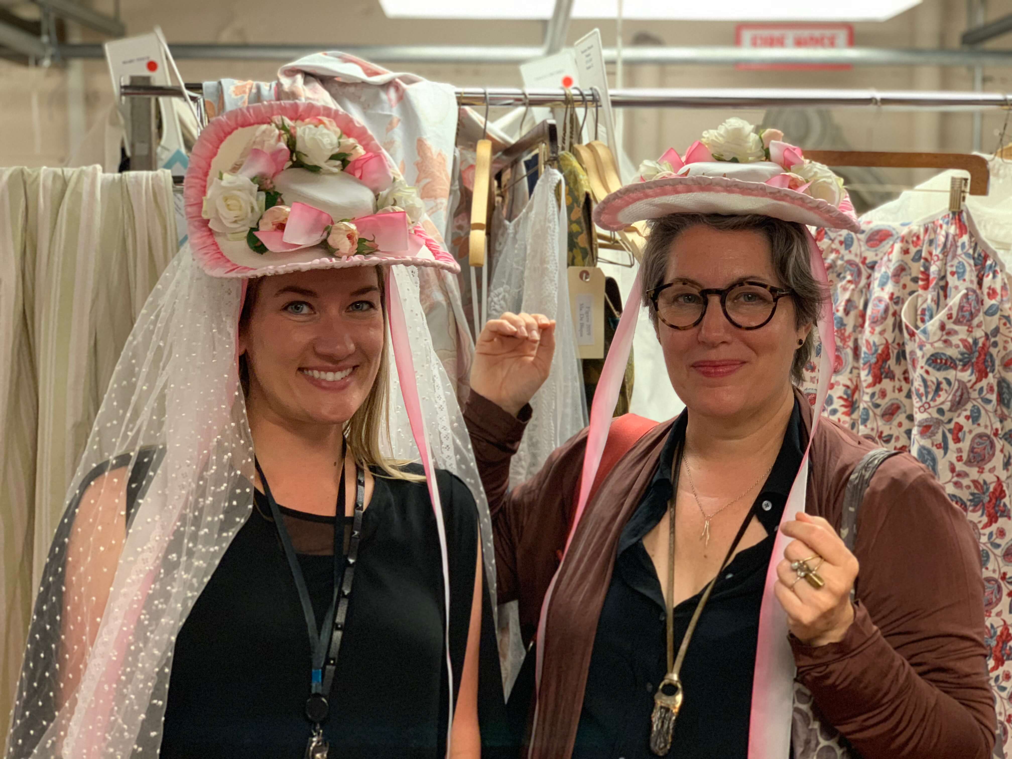 Galen and Constance showing the location of the magnets in two versions of Susanna&rsquo;s wedding hats, and showing off the hats!