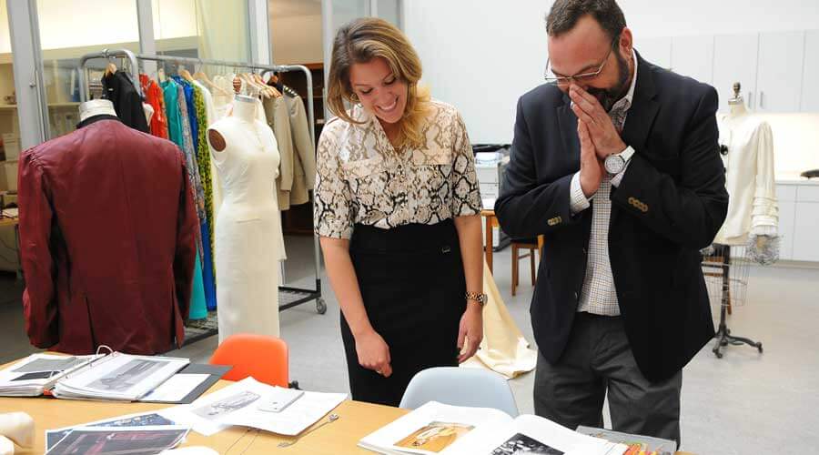 Christopher and Kari looking through designer books.