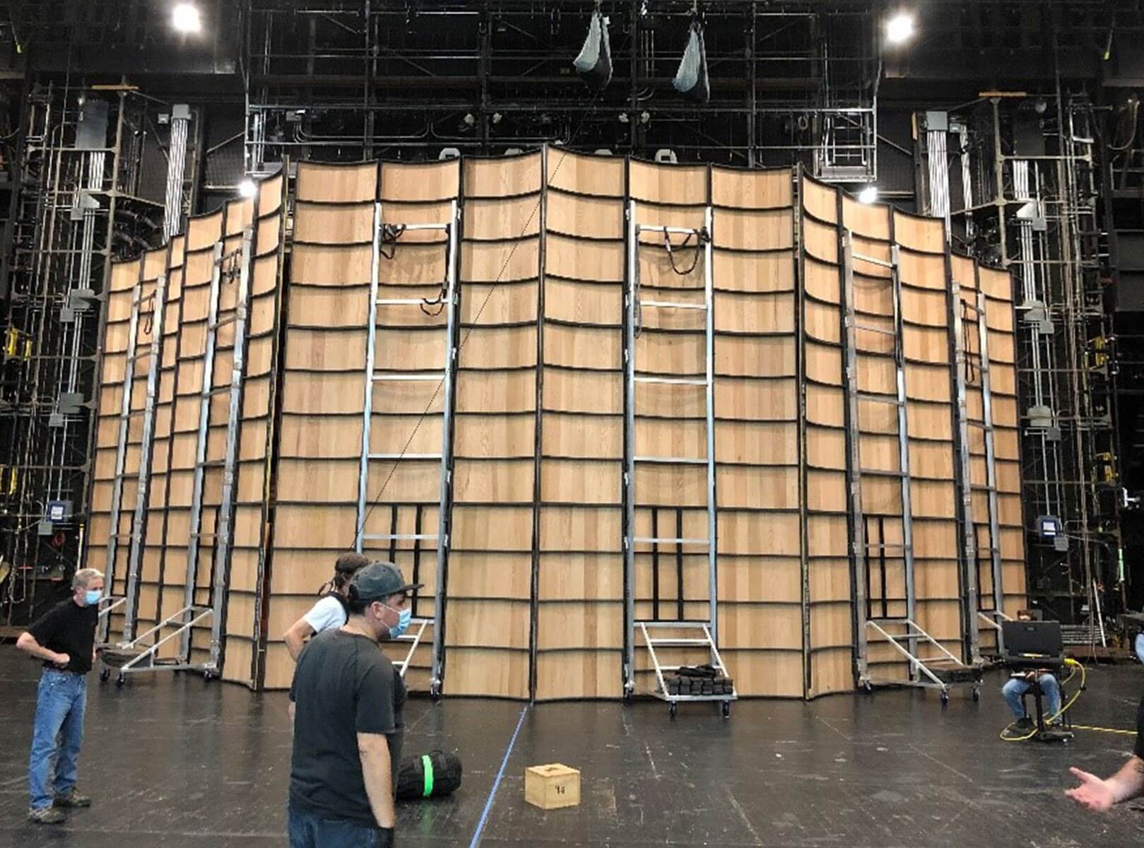 Members of the Opera stage crew with the rear of the orchestra shell