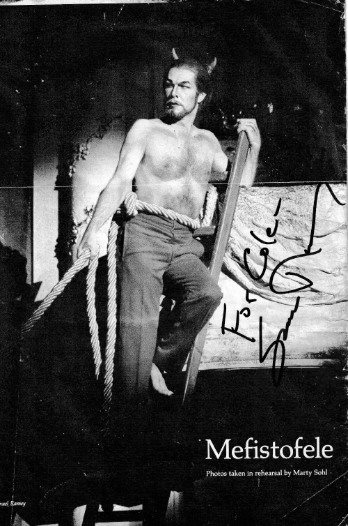 Mefistofele character on a ladder with a rope tied around his waist