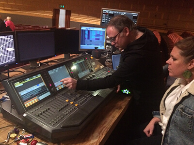 Katy Tucker and Erik Docktor working together on the media server.