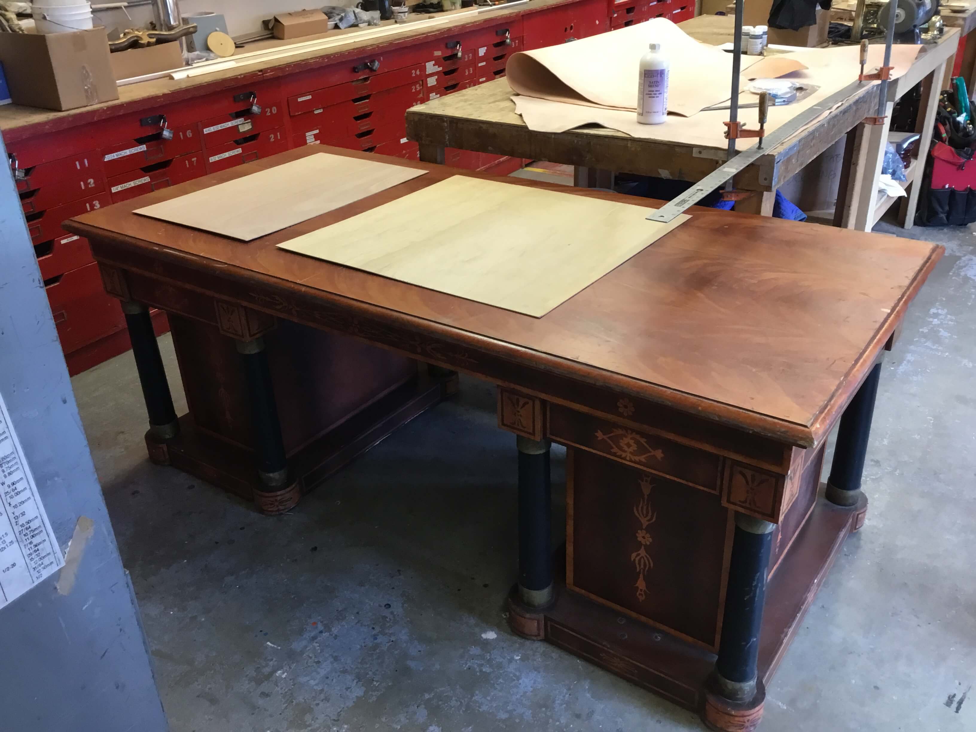Sarah Shores, in conversation with Properties Master, Lori Harrison, talking about the leather before it is cut for Scarpia&rsquo;s desk (and the to-be-worked-on desk).