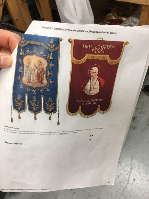 Tara Pellack stitching one of the banners for Act I of Tosca using an actual church painting at the center and banner research.
