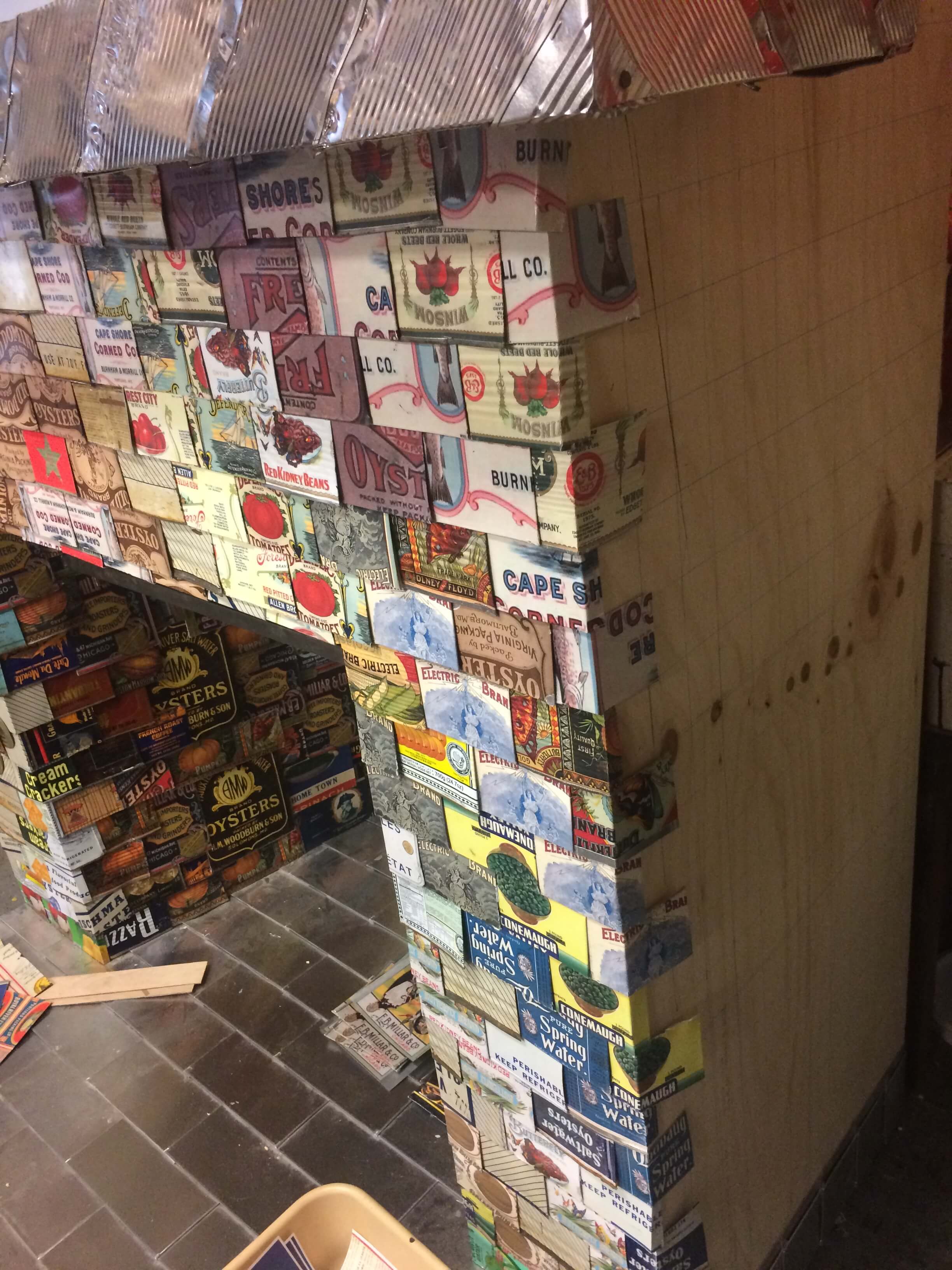 The can shingles are added to the wooden fireplace.