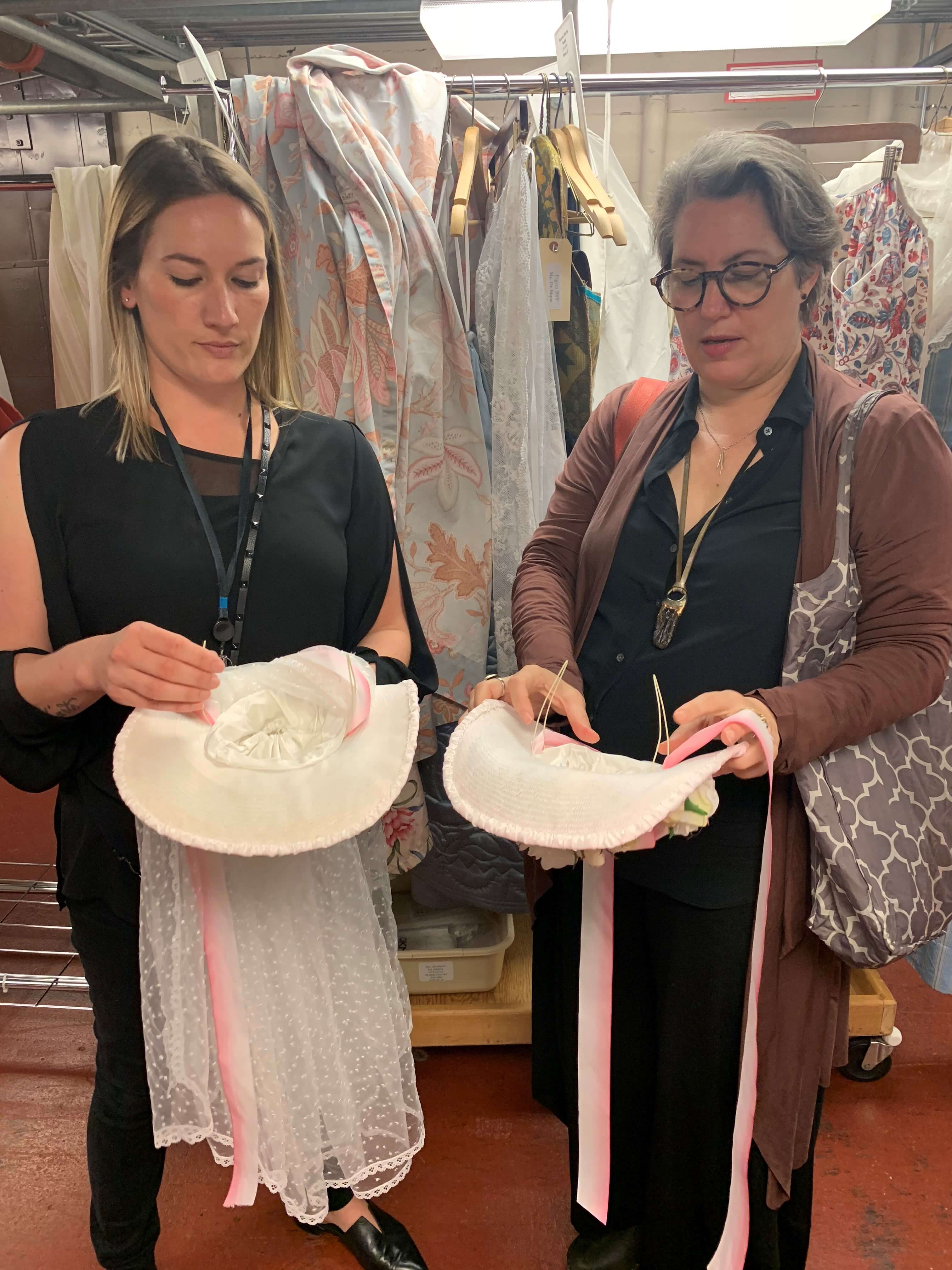 Galen and Constance showing the location of the magnets in two versions of Susanna&rsquo;s wedding hats, and showing off the hats!