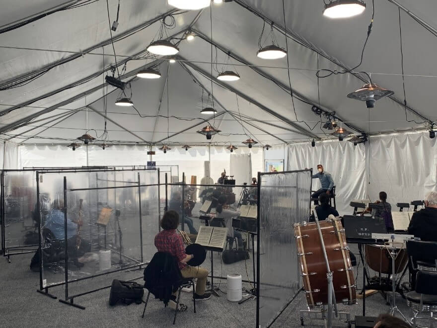 Clear panels that separate the wind players from the strings and percussion.